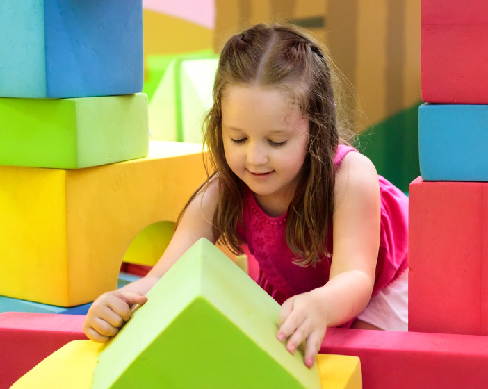 Girl playing with soft play block